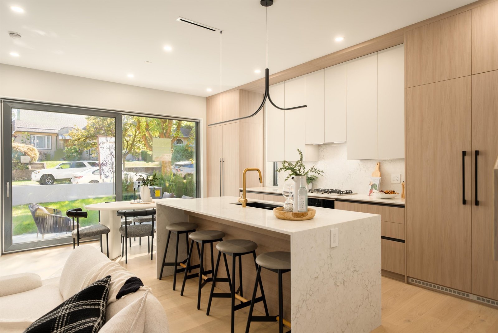 Kitchen island with dining and patio doors at 1-2941 W 29th Ave, Mackenzie Heights, Vancouver